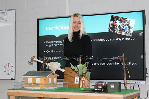 Communications and PR Coordinator Laura Spellman educates students at Meigs Middle School about electrical safety.